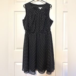 Black dress with white flowers and elastic waist.